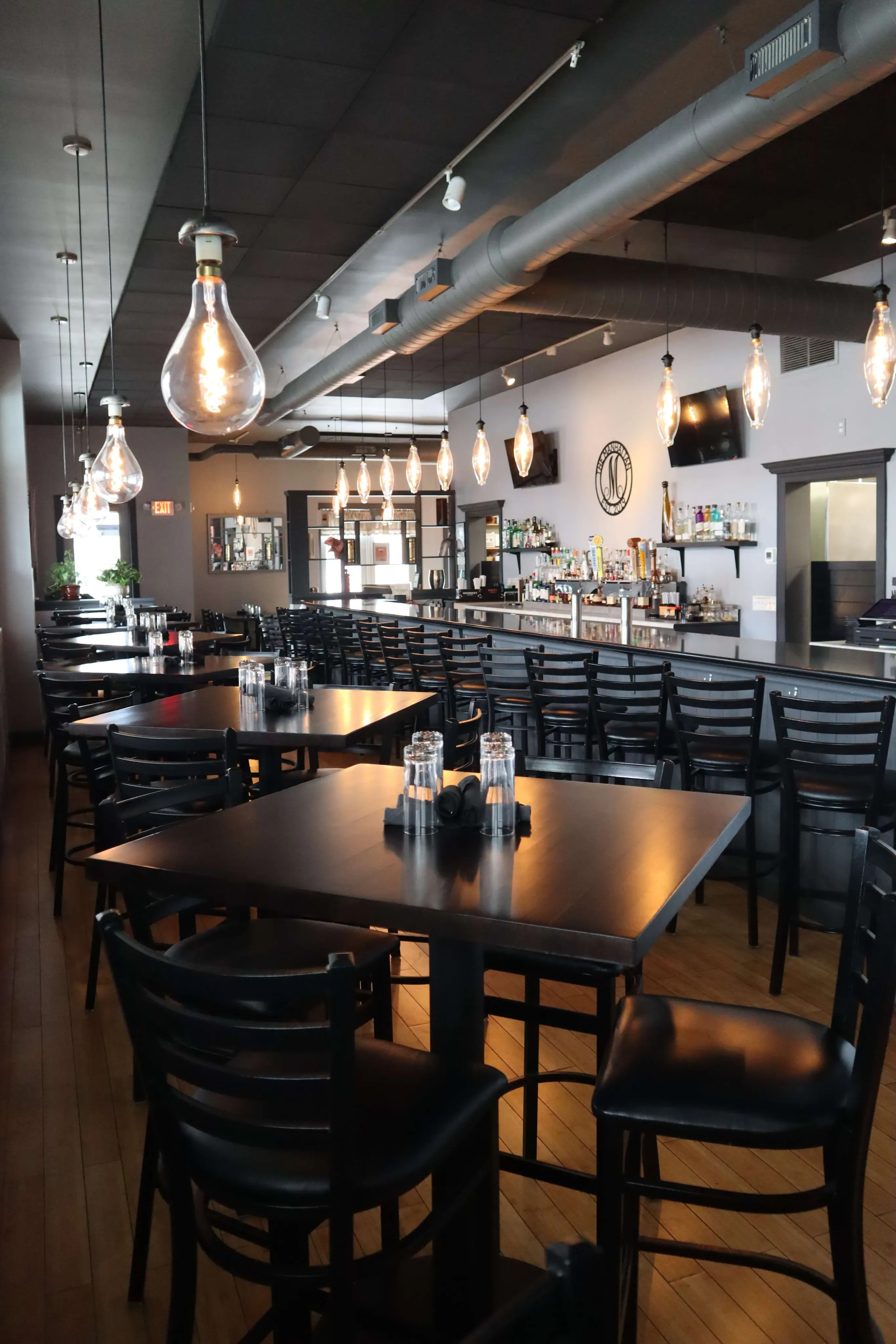 The Manhattan dining room with pendant lights and bar